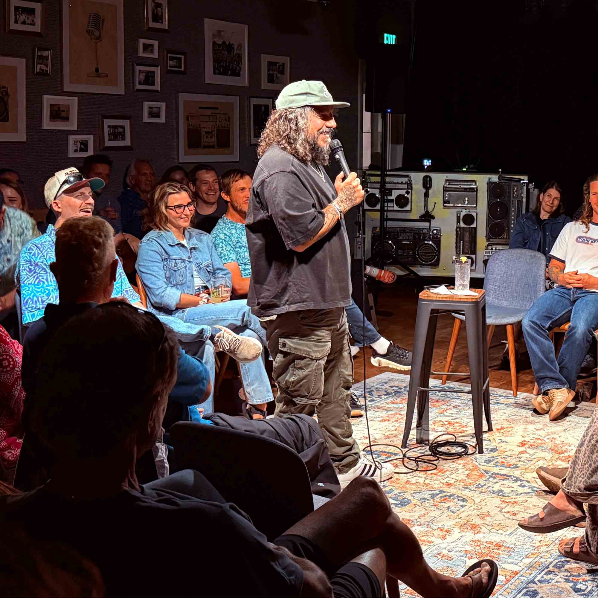 Comedian working the crowd in an intimate seated show at the Snowmass Live Comedy Series, The Collective Snowmass