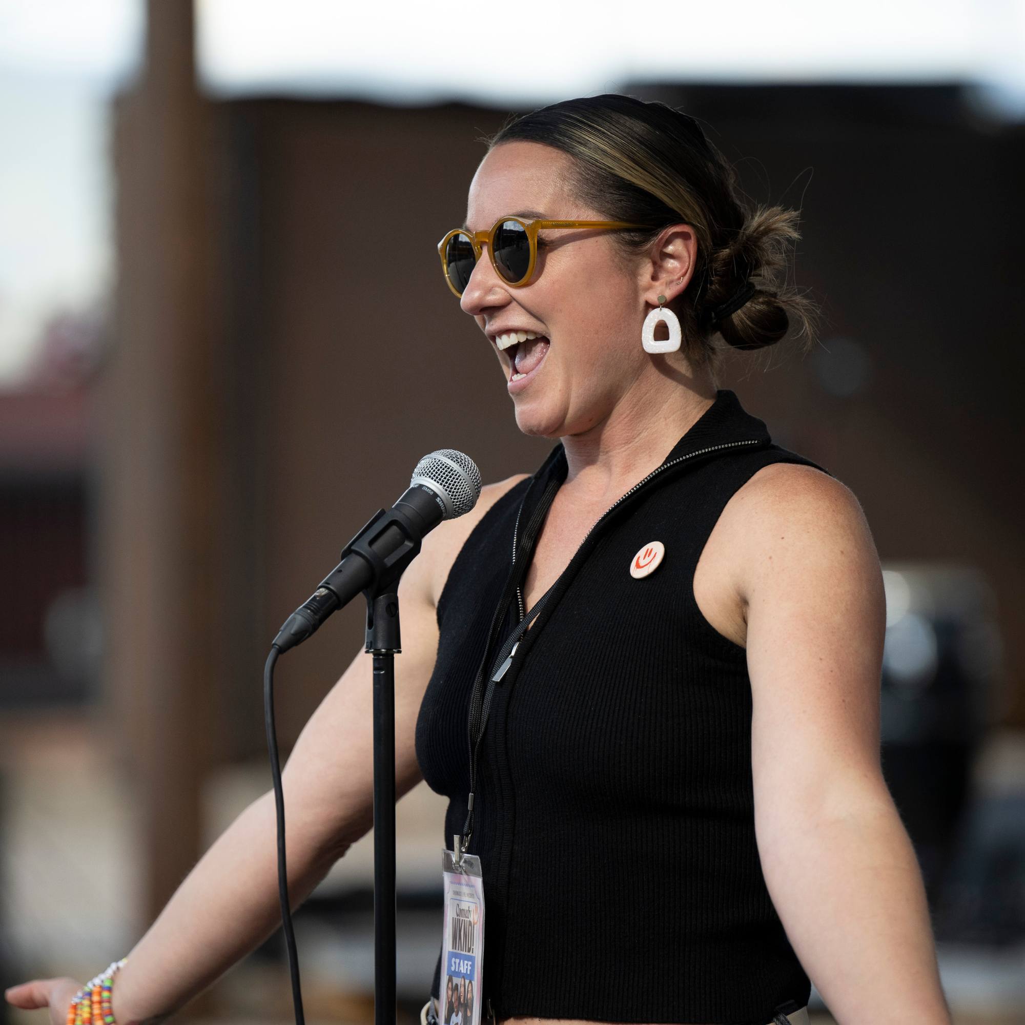 Host laughing at the microphone stand at Snowmass Live Comedy WKND!, The Collective Snowmass