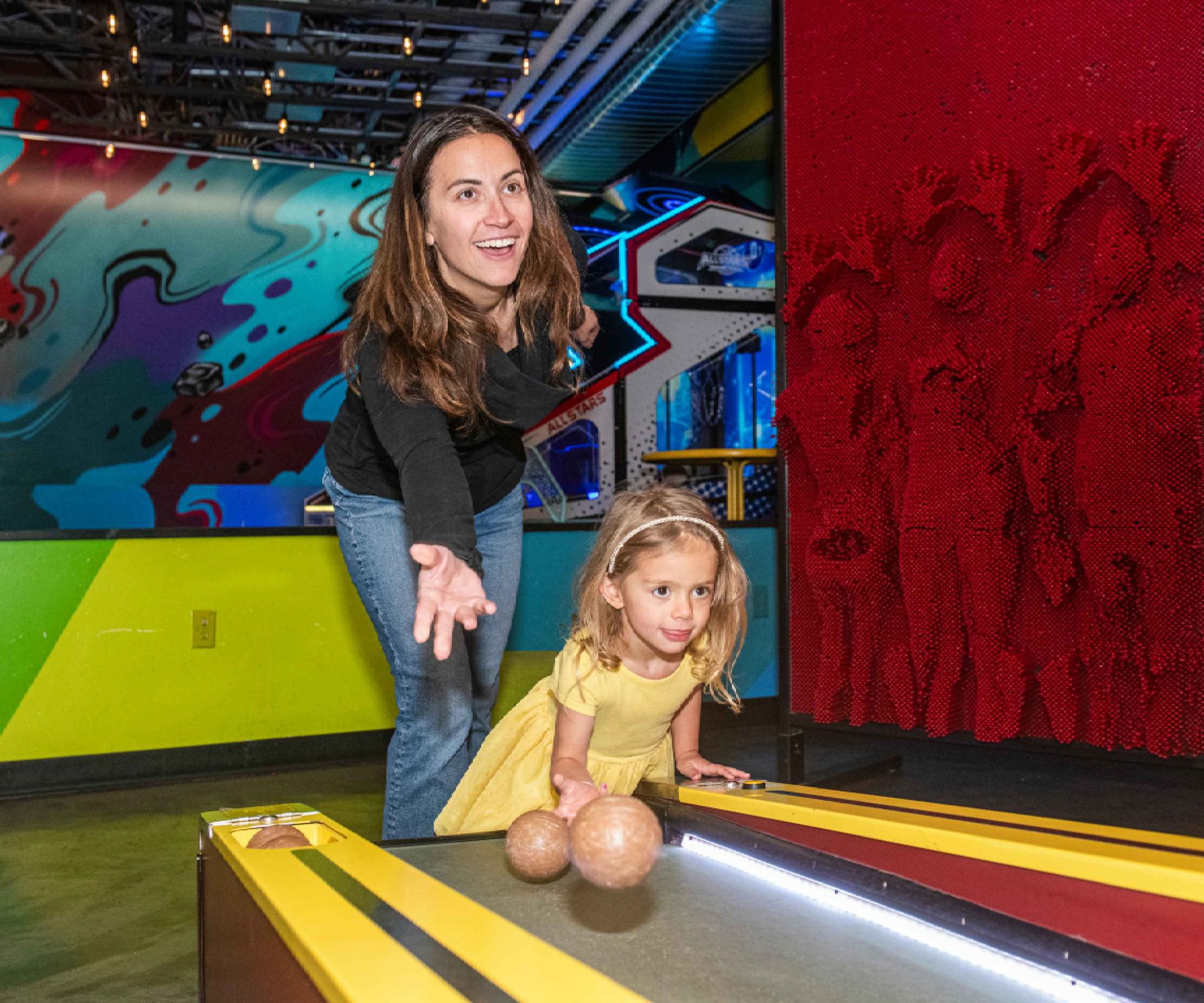 Mom and daughter playing skee-ball in the Game Lounge, The Collective Snowmass
