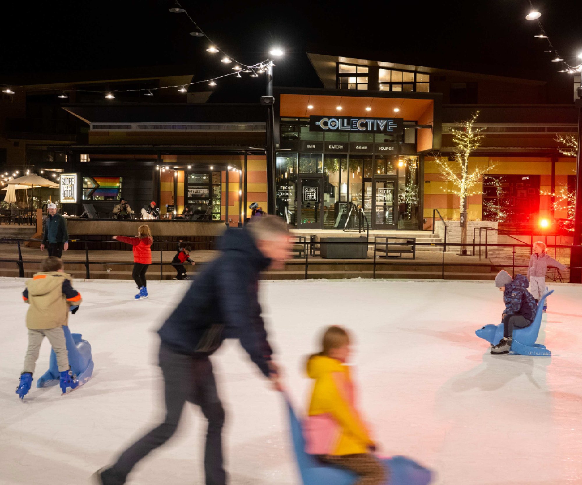 Skaters on The Rink at night in front of The Collective, The Collective Snowmass