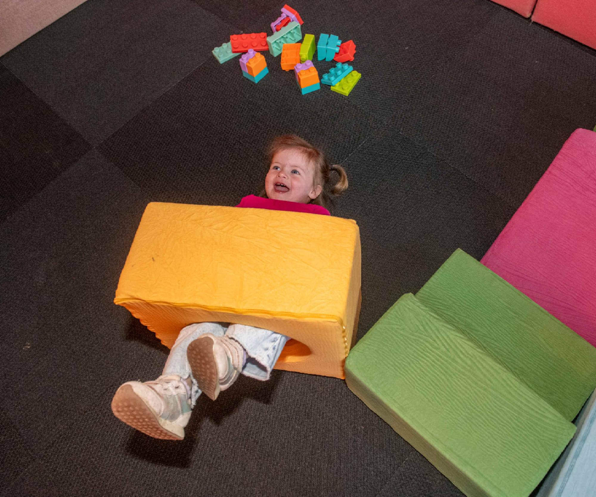 Toddler playing with soft blocks at Toddler Time, The Collective Snowmass